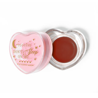 Pink heart-shaped lip sleeping mask with the lid off on a white background